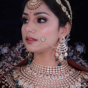 About Us Close-up portrait of an Indian bride wearing traditional jewelry and attire.