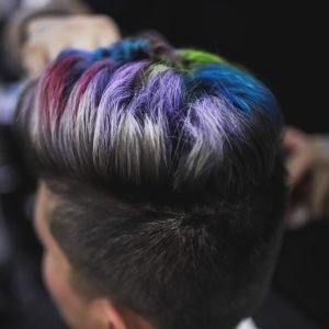 Home Close-up of a stylish multi-colored hairstyle showing vibrant rainbow hues, capturing modern hair artistry.